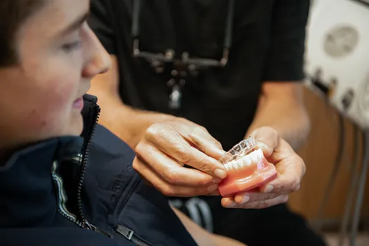 dentist showing patient clear aligners