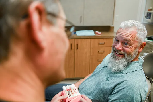 patient smiling in blue shirt