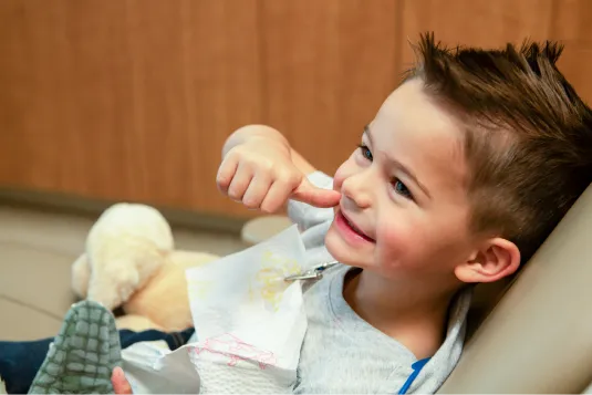 kid pointing to his teeth