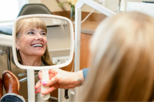 patient smiling in mirror