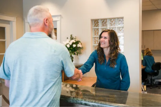 patient shaking womens hand