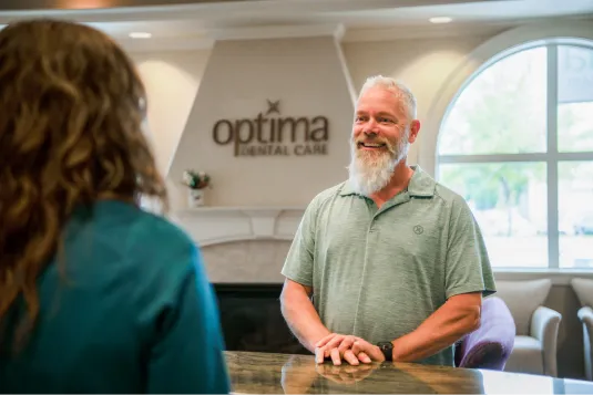 patient standing infront of sign