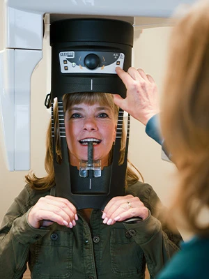 Patient getting a 3D dental scan using CS 8100 imaging system