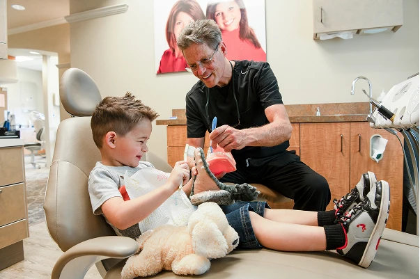 Dr. Johnson showing a model of teeth to a patient