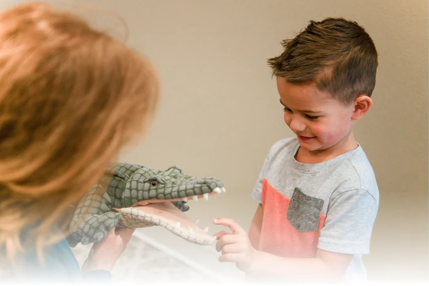 kid playing with aligator